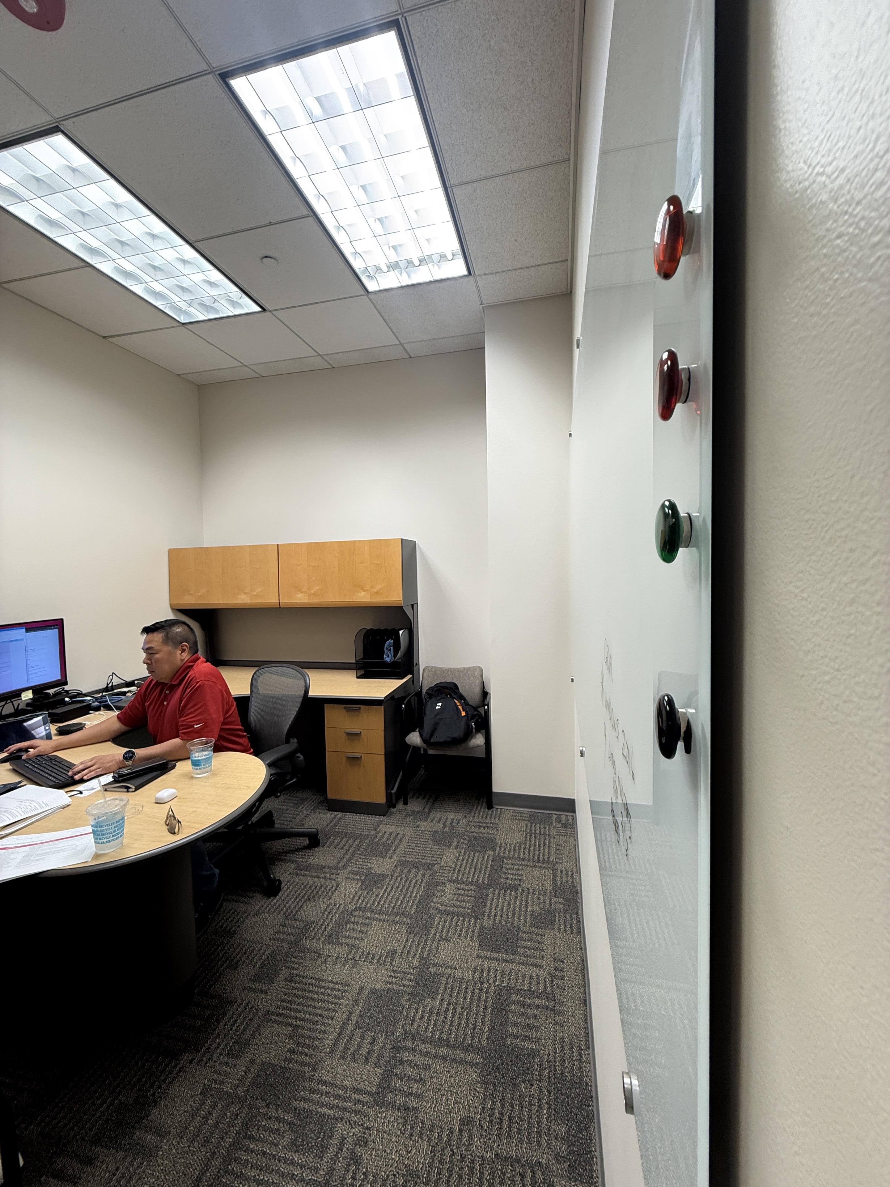 Joseph Park working in a conference room with a laptop and monitor.