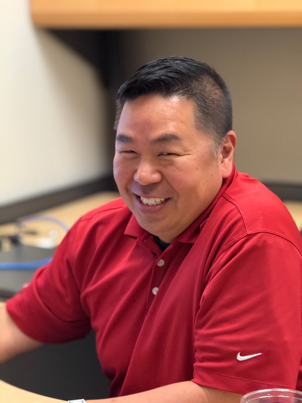 Joseph Park smiling in an office setting.